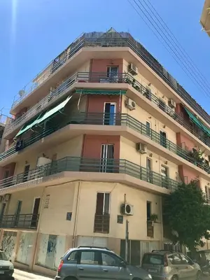 a building with cars parked in front of it at Elea Athens Apartment in Athens