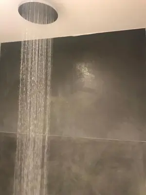 a shower with a stream of water in a bathroom at Elea Athens Apartment in Athens