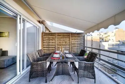 a balcony with a table and chairs on a balcony at Elea Athens Apartment in Athens