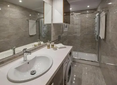 a bathroom with a white sink and a shower at Spacious & convenient place near Acropolis Museum by GHH in Athens