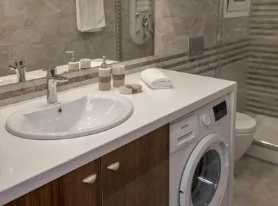 a bathroom with a sink and a washing machine at Spacious & convenient place near Acropolis Museum by GHH in Athens