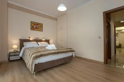 a bedroom with a bed with two stuffed animals on it at Spacious & convenient place near Acropolis Museum by GHH in Athens