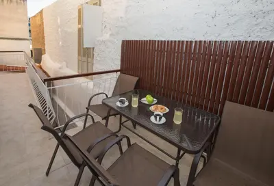 a table with a plate of food on a balcony at Spacious & convenient place near Acropolis Museum by GHH in Athens