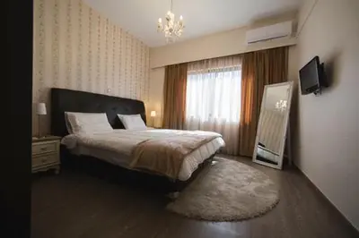 a bedroom with a large bed and a window at MARGARITA'S SUITES in Athens