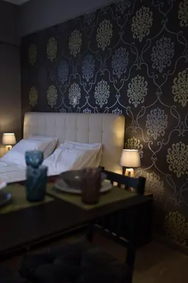 a bedroom with a bed and a table with plates on it at MARGARITA'S SUITES in Athens