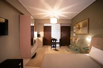 a living room with a bed and a table at MARGARITA'S SUITES in Athens