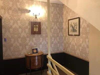 a room with a staircase with a table and wallpaper at MARGARITA'S SUITES in Athens