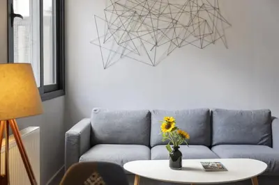a living room with a couch and a table at Super modern minimal flat nr metro & arch. Museum in Athens