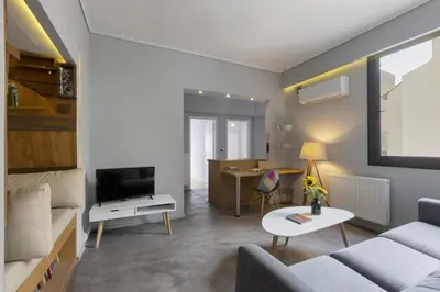 a living room with a couch and a table at Super modern minimal flat nr metro & arch. Museum in Athens