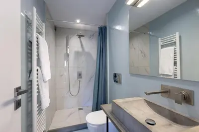 a bathroom with a shower and a sink at Super modern minimal flat nr metro & arch. Museum in Athens