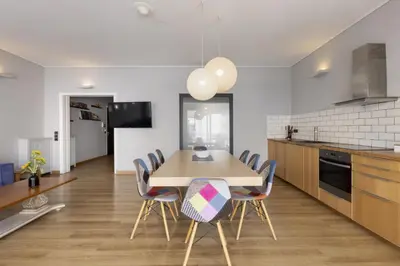 a kitchen and dining room with a wooden table and chairs at Super modern minimal flat nr metro & arch. Museum in Athens