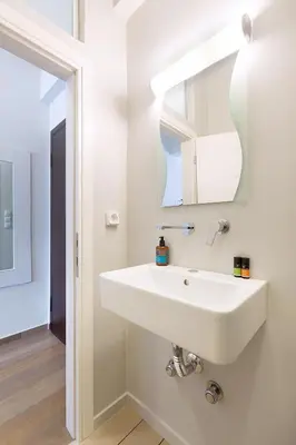 a bathroom with a white sink and a mirror at luxury kolonaki studio in Athens
