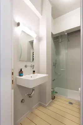 a white bathroom with a sink and a shower at luxury kolonaki studio in Athens