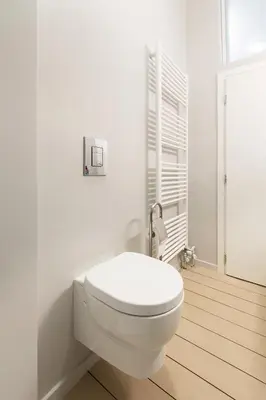 a white bathroom with a toilet in a room at luxury kolonaki studio in Athens