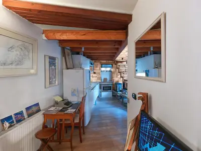 a kitchen with a table and a refrigerator at Live at the Acropolis shadow - under super scenic Anafiotika in Athens