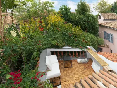 an outdoor patio with flowers on a house at Live at the Acropolis shadow - under super scenic Anafiotika in Athens