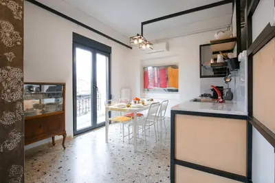 a kitchen and dining room with a table and chairs at Semedaki, design in the centre of history in Athens
