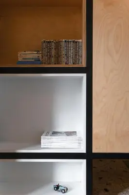 a book shelf with a pile of books at Semedaki, design in the centre of history in Athens
