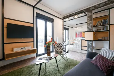 a living room with a couch and a tv at Semedaki, design in the centre of history in Athens