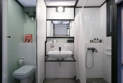 a bathroom with a sink and a toilet and a shower at Semedaki, design in the centre of history in Athens