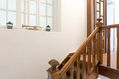 a wooden staircase in a house with a table at Acropolis Heights at the foot of the Parthenon in Athens