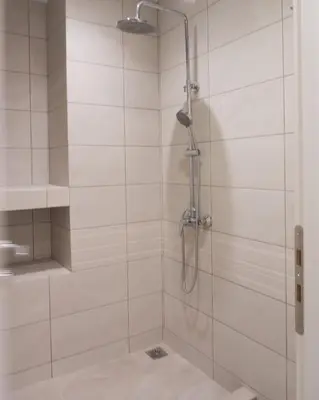a bathroom with a shower with a glass door at Acropolis Heights at the foot of the Parthenon in Athens