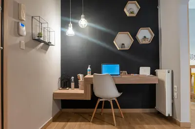 an office with a desk with a laptop and a chair at Maria's Home in Athens