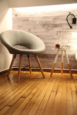 a chair and a side table in a room at Maria's Home in Athens
