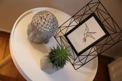a white plate with a statue and a plant on it at Maria's Home in Athens