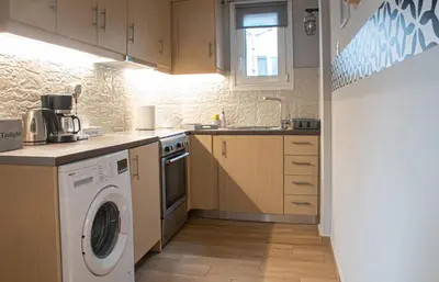 a kitchen with a washing machine and a washer at Maria's Home in Athens