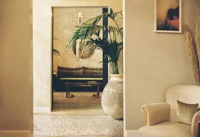 a living room with a couch and a mirror at Shila Athens in Athens