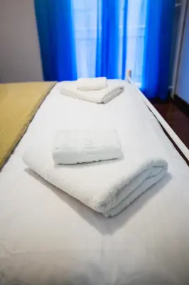 two towels are sitting on top of a bed at Alkamenous Apartment Petros VIPGreece in Athens