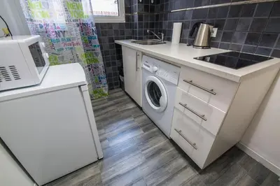 a kitchen with a washing machine and a sink at Alkamenous Apartment Petros VIPGreece in Athens