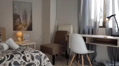 a bedroom with a desk and a bed and a chair at Palette Apartment Champagne - Athens Center, 6 BD, 3 BATH in Athens