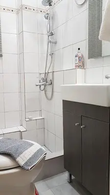 a bathroom with a shower and a sink and a toilet at Palette Apartment Champagne - Athens Center, 6 BD, 3 BATH in Athens