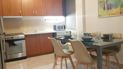 a kitchen with a table and chairs in a kitchen at Palette Apartment Champagne - Athens Center, 6 BD, 3 BATH in Athens