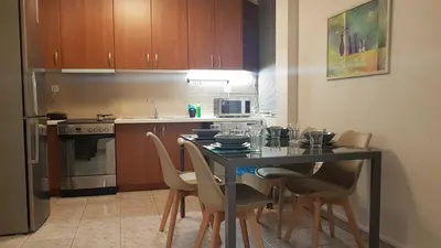 a kitchen with a table and chairs in a kitchen at Palette Apartment Champagne - Athens Center, 6 BD, 3 BATH in Athens