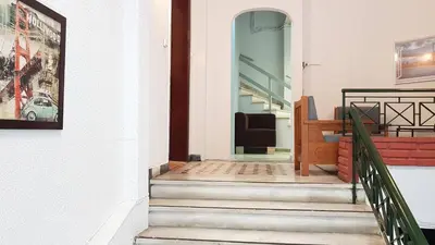 a stairway leading into a building with a glass door at Palette Apartment Champagne - Athens Center, 6 BD, 3 BATH in Athens