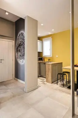 a kitchen with yellow walls and a table with chairs at Modern Design Acropolis Flat in Athens