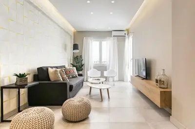 a living room with a couch and a tv at Modern Design Acropolis Flat in Athens