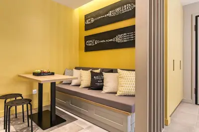 a room with a bench with pillows and a table at Modern Design Acropolis Flat in Athens