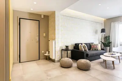a living room with a couch and a table at Modern Design Acropolis Flat in Athens