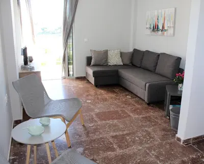 a living room with a couch and a table at Apartments MARE BLU by the sea. in Porto Rafti