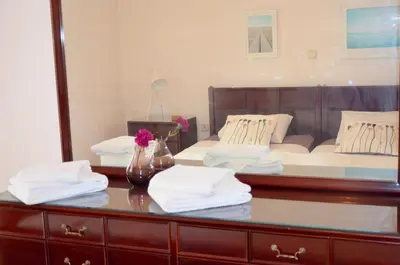a bedroom with a bed and a table with towels at Retro Apartment at Trendy Exarcheia in Athens