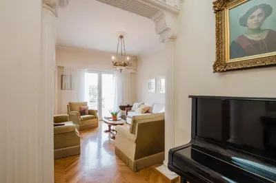 a living room with a flat screen tv and a couch at Retro Apartment at Trendy Exarcheia in Athens