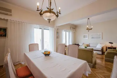a dining room with a table and a living room at Retro Apartment at Trendy Exarcheia in Athens