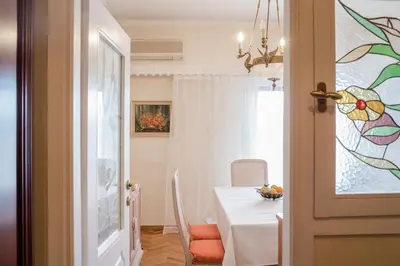 a dining room with a table and a white table and a window at Retro Apartment at Trendy Exarcheia in Athens