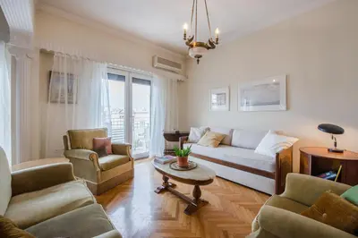 a living room with a couch and chairs and a table at Retro Apartment at Trendy Exarcheia in Athens
