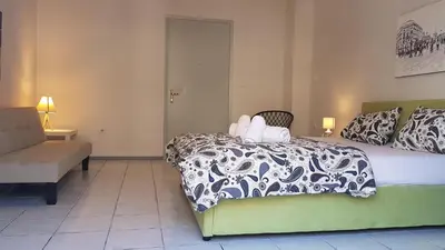 a bedroom with a bed with a white and black comforter at Palette Apartment Carmine - Athens Center, 6 BD, 3 BATH in Athens