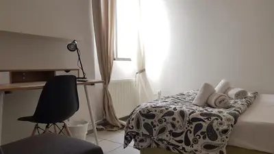 a bedroom with a bed with a desk and a chair at Palette Apartment Carmine - Athens Center, 6 BD, 3 BATH in Athens
